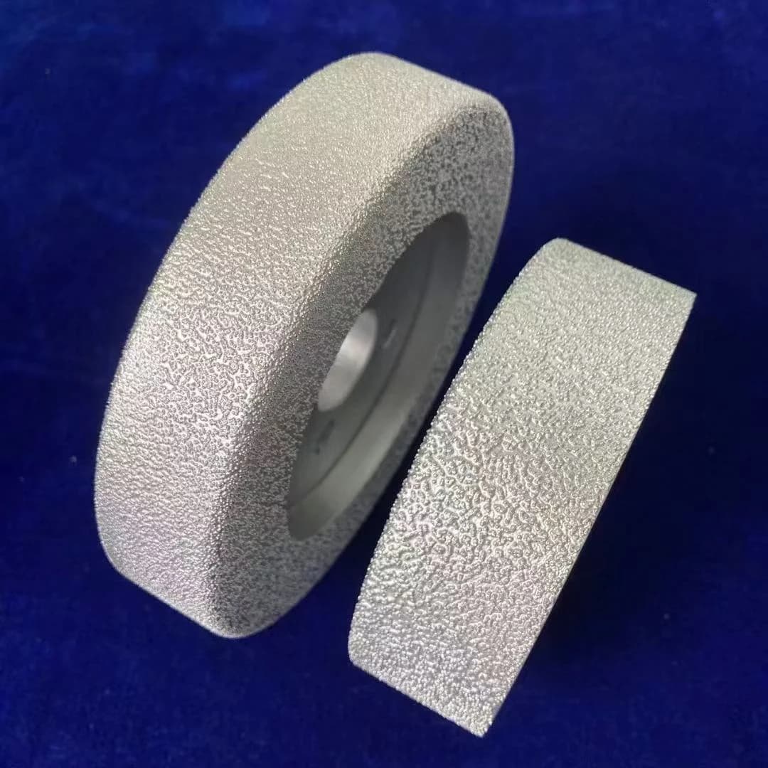 brazed diamond wheel with a central bore beside a flat coated plate